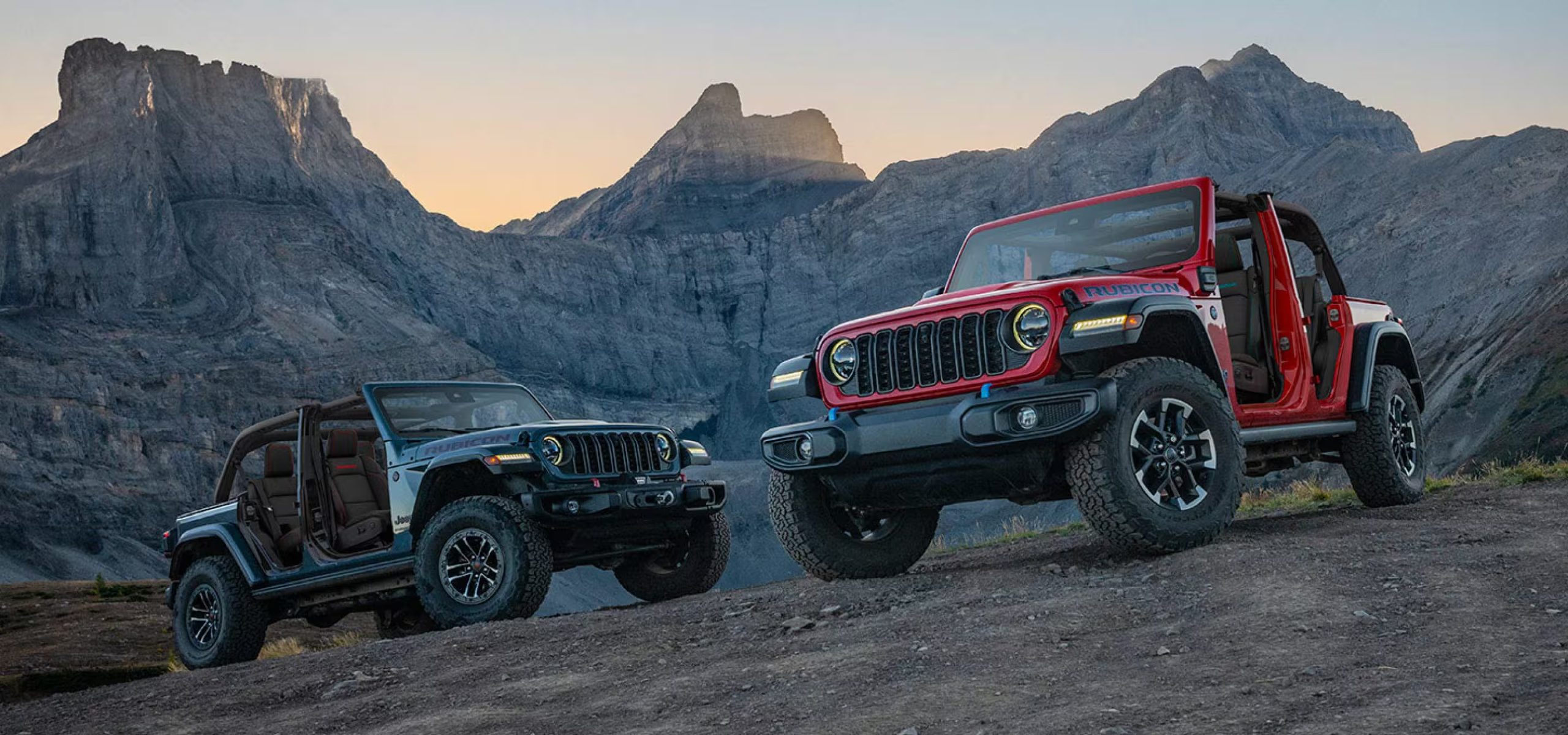 Two 2025 Jeep Wrangler parked on rocky mountain top