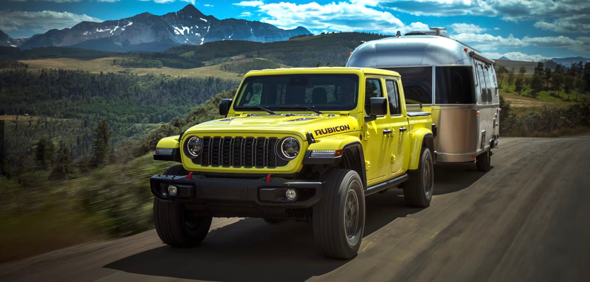 The new Jeep Gladiator pulling a trailer through the countryside of Baraboo, WI on an road trip across the US.