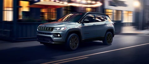 A 2026 Jeep Compass SUV is shown backing up toward a wall. | Bachrodt Baraboo Motors in Baraboo WI