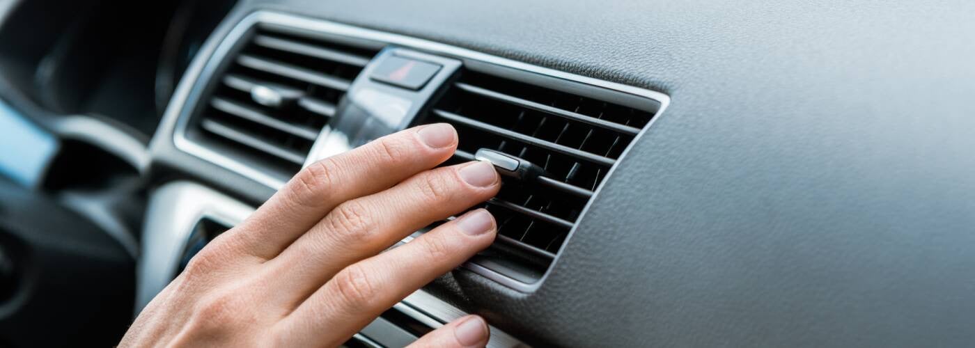 a close up image of a hand testing a vehicle's AC
